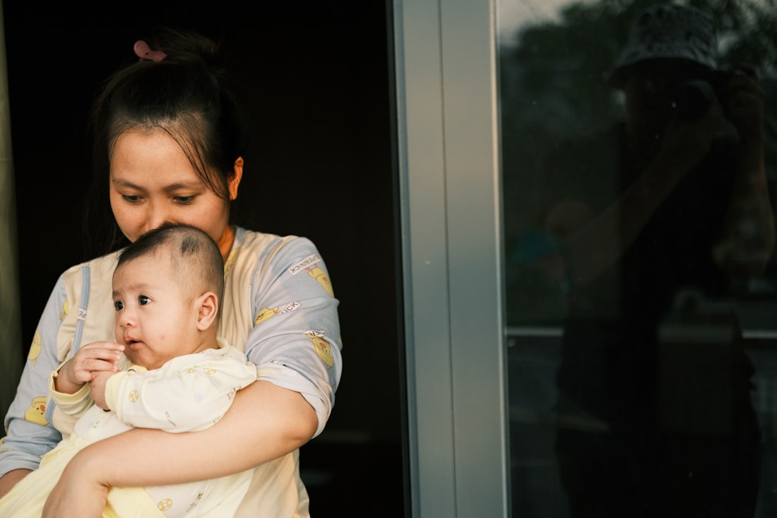 A mother holding her baby close